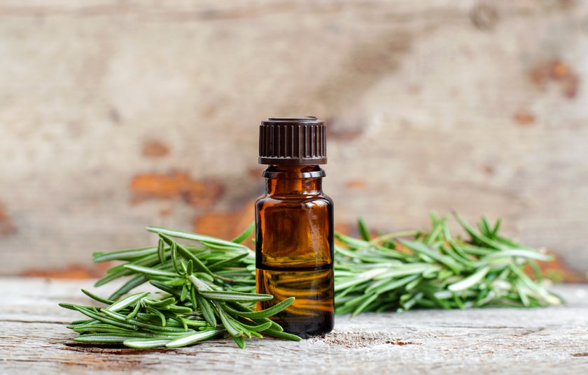 Small bottle of essential rosemary oil on the old wooden background. Aromatherapy, spa and herbal medicine ingredients. Copy space. Small bottle of essential rosemary oil on the old wooden background. Aromatherapy, spa and herbal medicine ingredients. Copy space.