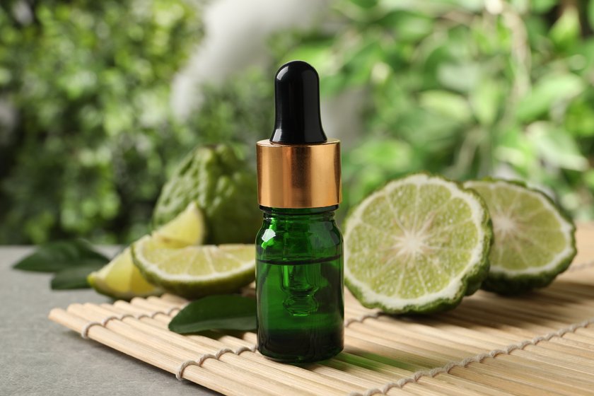 Glass bottle of bergamot essential oil on table Glass bottle of bergamot essential oil on table