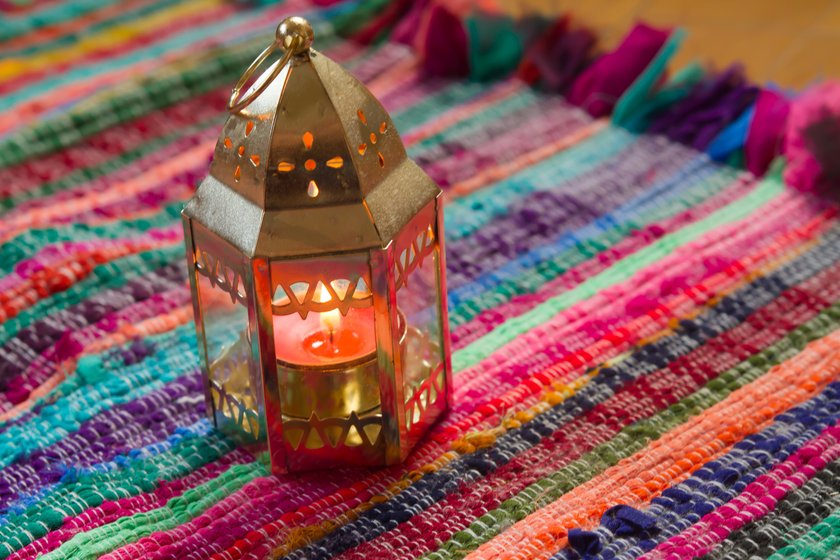 glod candle on a colorful fabric.