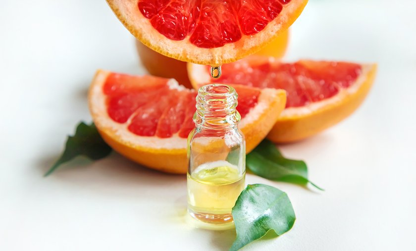 Grapefruit essential oil in a small bottle. Selective focus. Food. Grapefruit essential oil in a small bottle. Selective focus. Food.