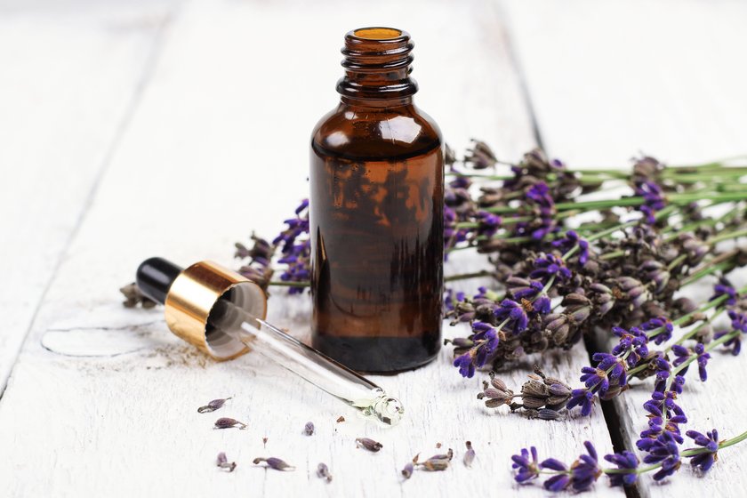 Still life, health and beauty, spa concept. Dry lavender and oil on a white wooden table. Selective focus Still life, health and beauty, spa concept. Dry lavender and oil on a white wooden table. Selective focus